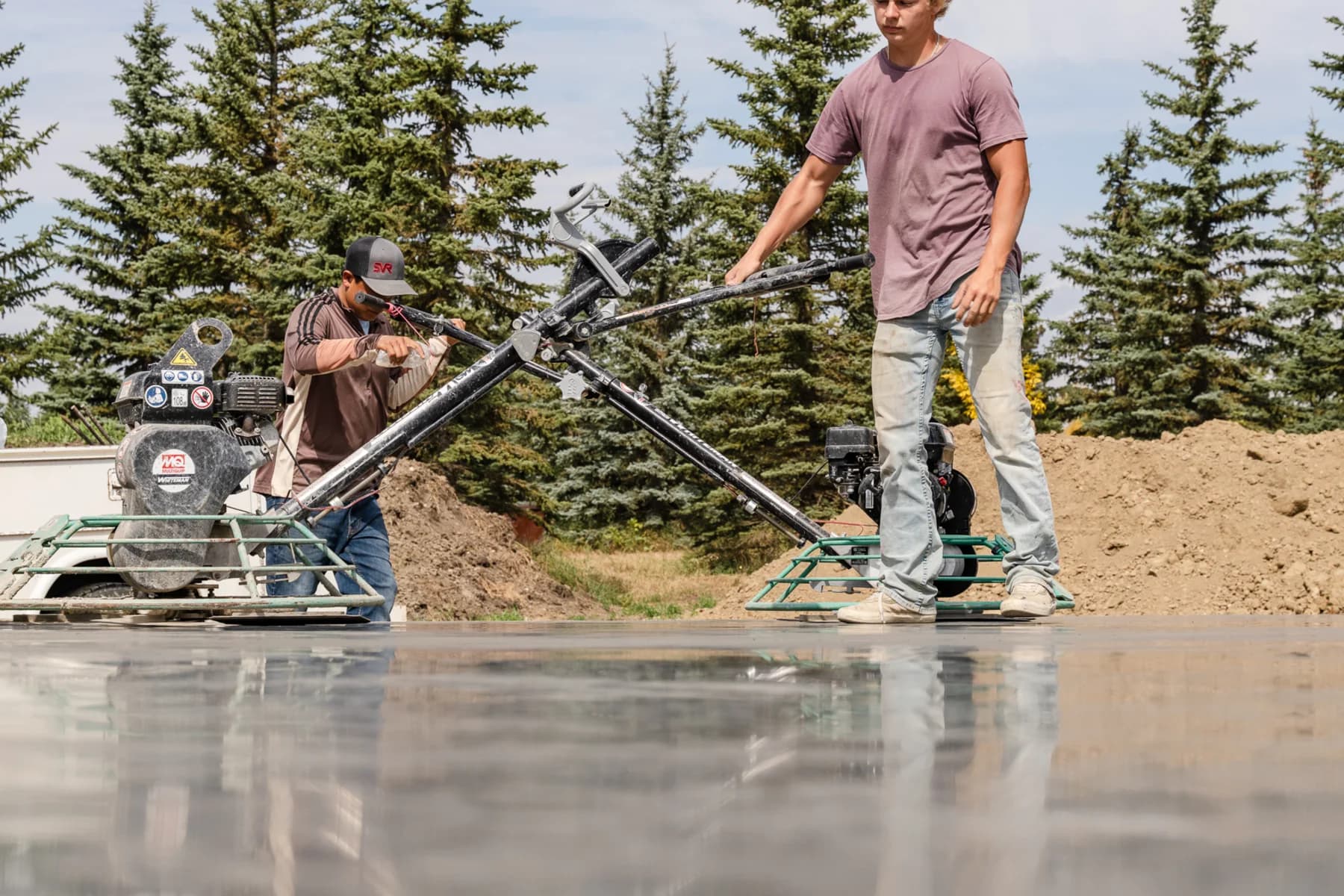 Crew member finishing a concrete slab for 48 North Concrete
