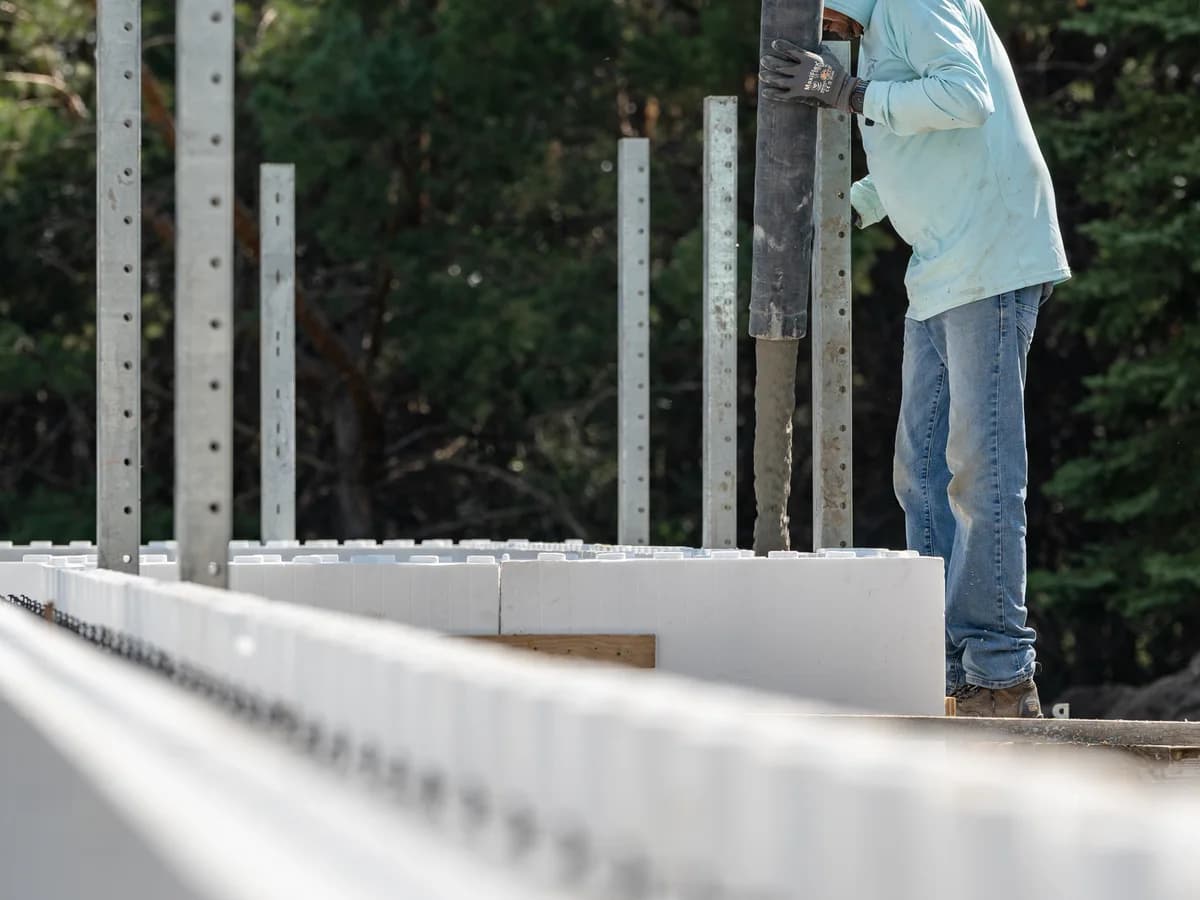 48 North Concrete crew member placing concrete into ICF forms